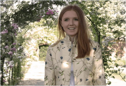 Woman with Silk embroidered cream jacket with floral detailing